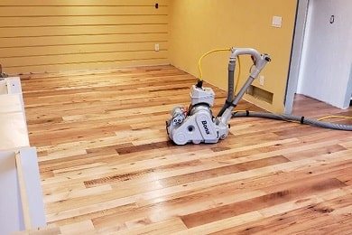 Belt sander on a raw hardwood floor