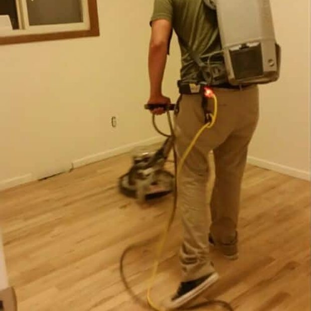 Running the belt sander across a floor