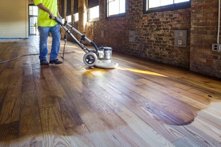 Buffing a hardwood floor in a Denver brick loft
